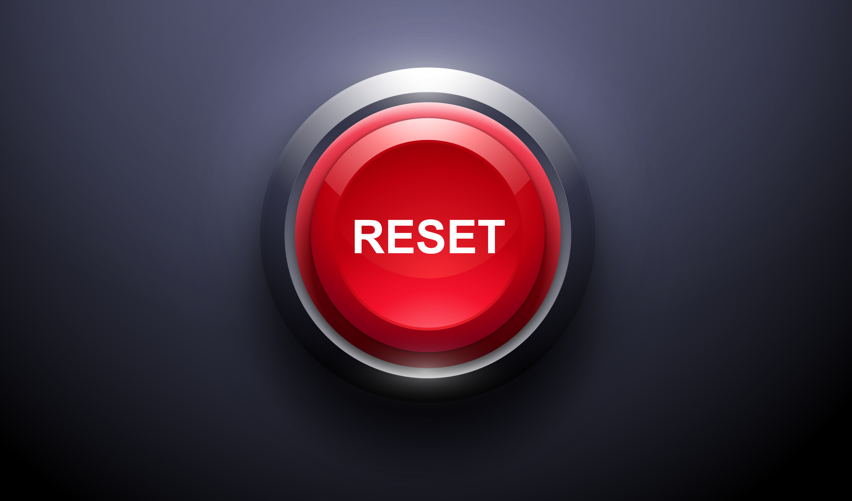 A close-up of a red reset button.