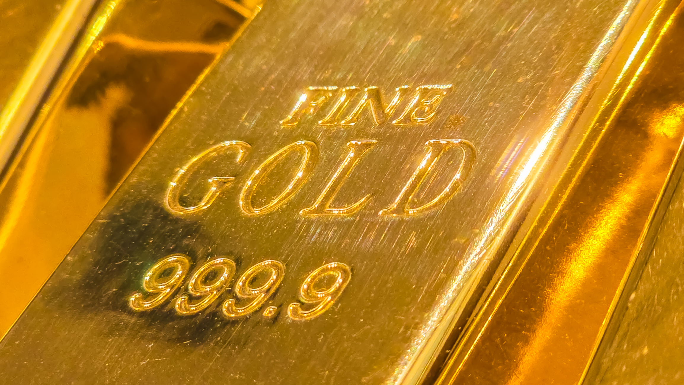 A shiny, solid gold bar representing a physical store of value.
