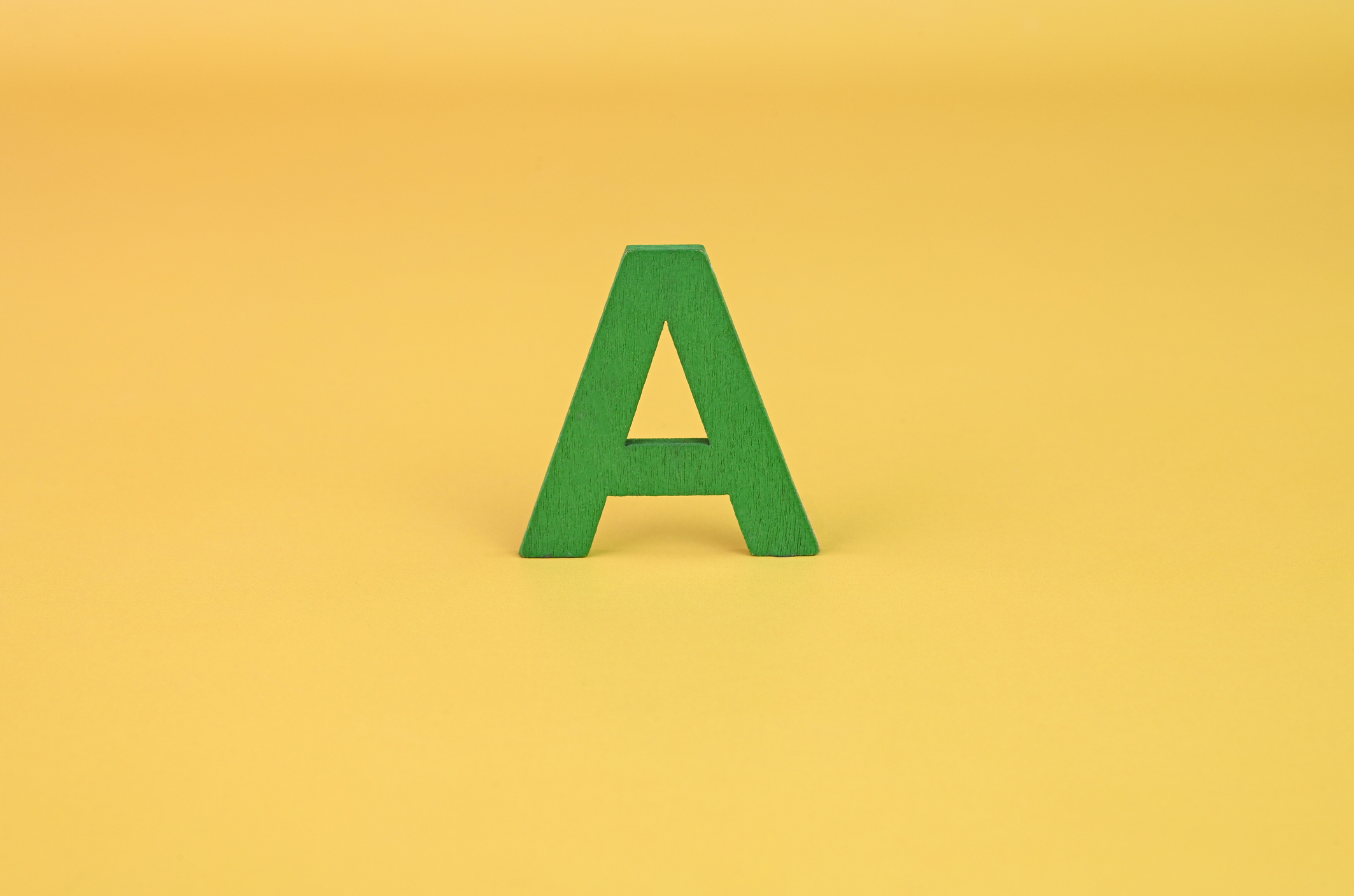 The letter A on a bright yellow background.