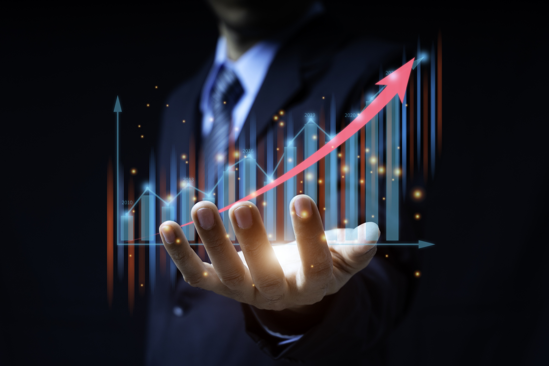 Symbolic representation of financial growth with a green plant sprouting from a pile of coins.