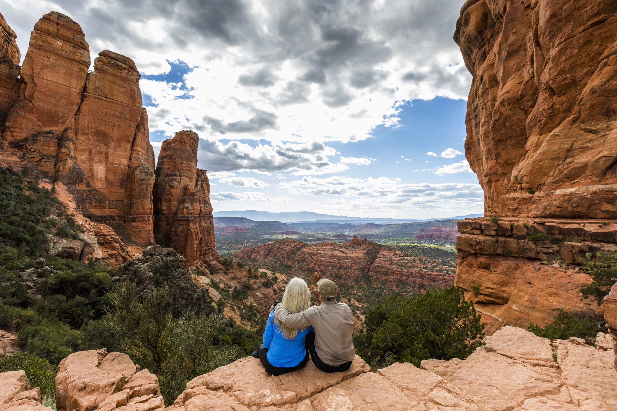 A senior couple enjoying a scenic view in a desert landscape.